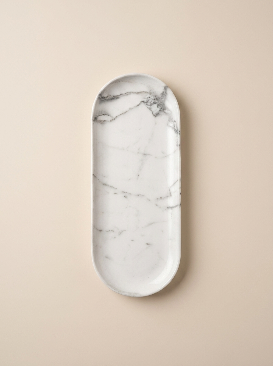 SURFACE I elliptical tray, cut from a single block of travertine